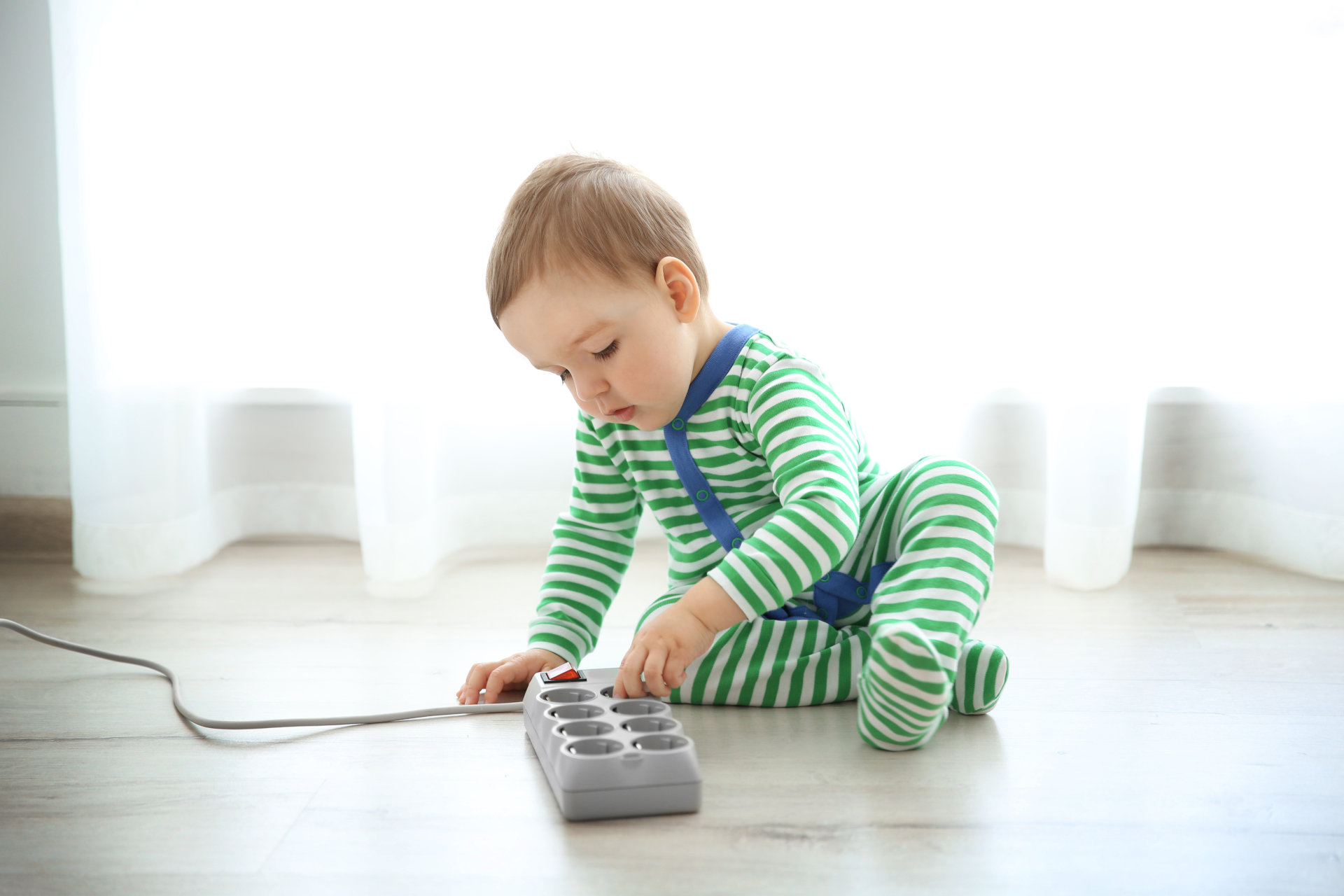 child playing with electical outlet